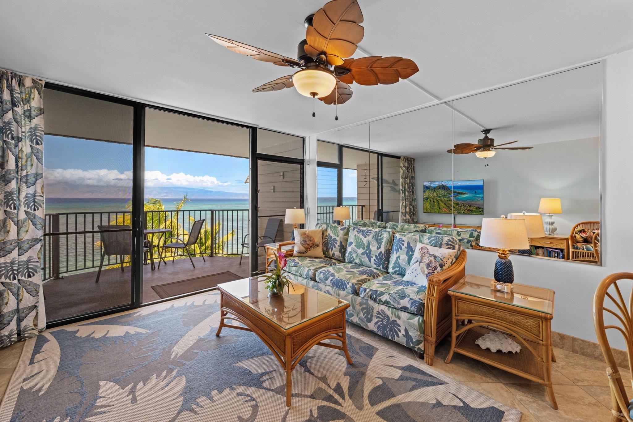 4471 Lower Honoapiilani Road, Unit 415 Lahaina, HI 96761 - Photo 7 of 44 a living room with furniture a ceiling fan and a large window