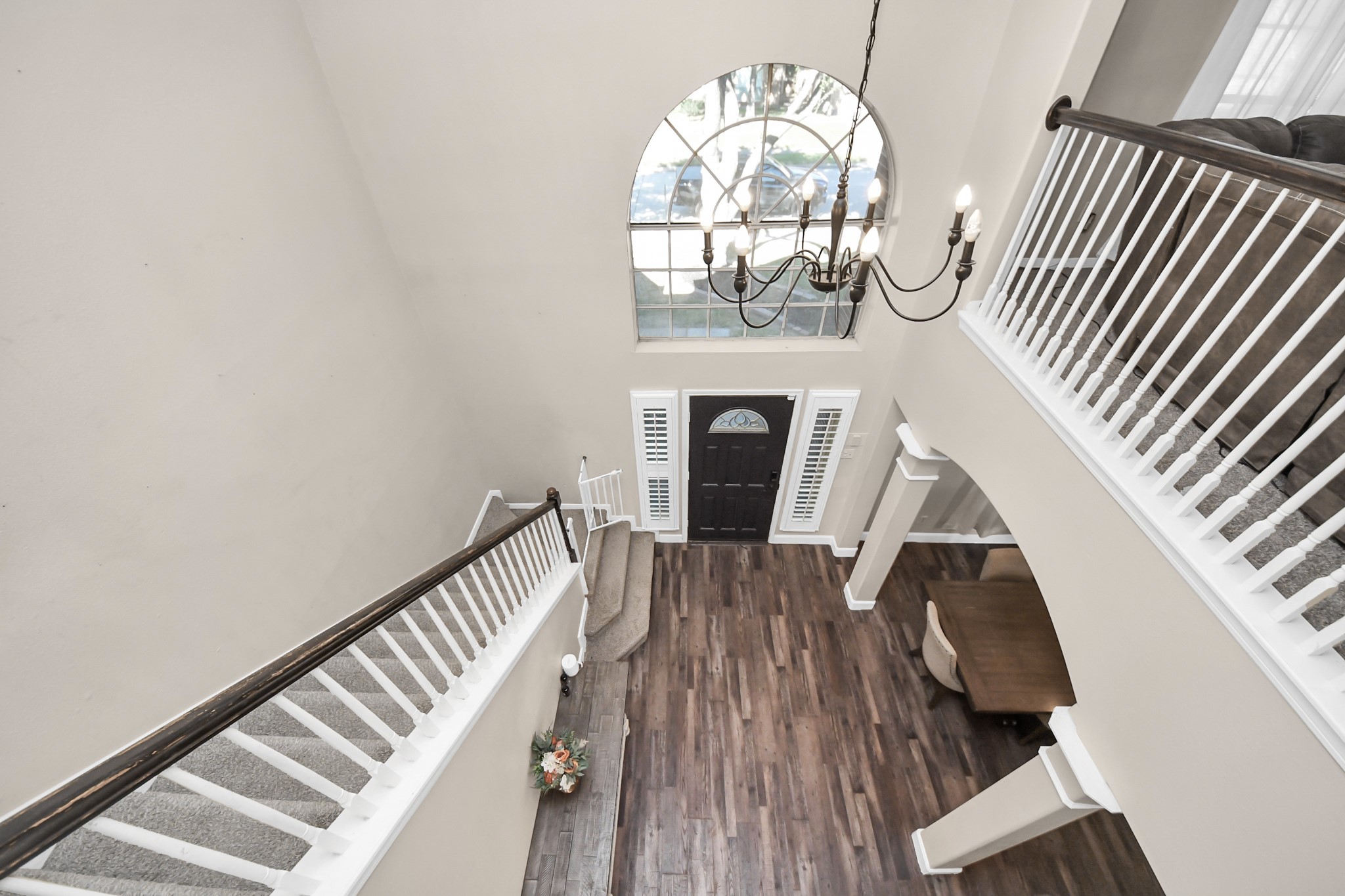 10514 Ravens Way Baytown, TX 77523 - Photo 15 of 50 View from the second floor overlooking the front entrance, emphasizing the open and welcoming entry.