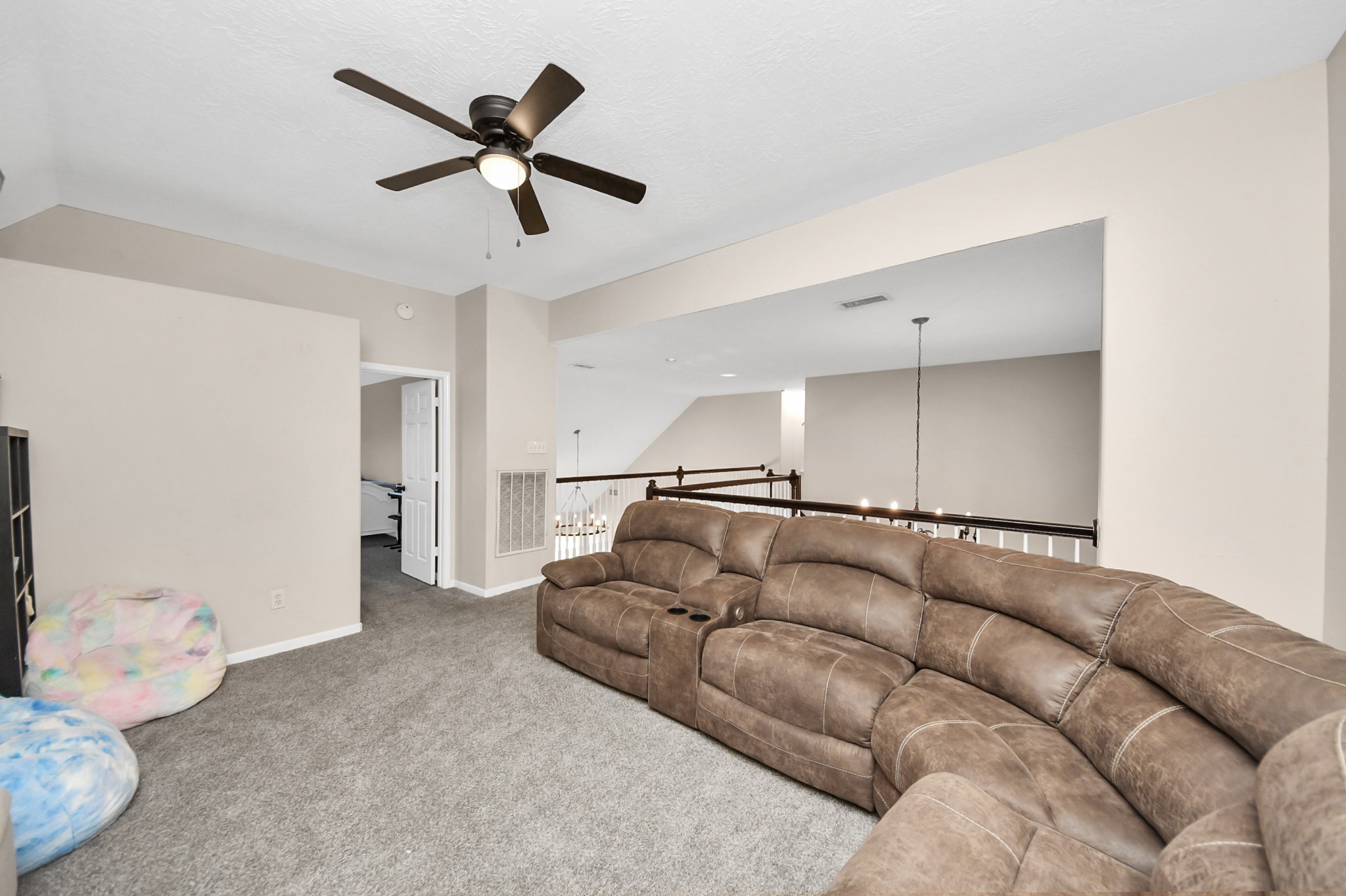 10514 Ravens Way Baytown, TX 77523 - Photo 18 of 50 Upstairs open area from one angle, perfect for a home office, game room, or additional living space.