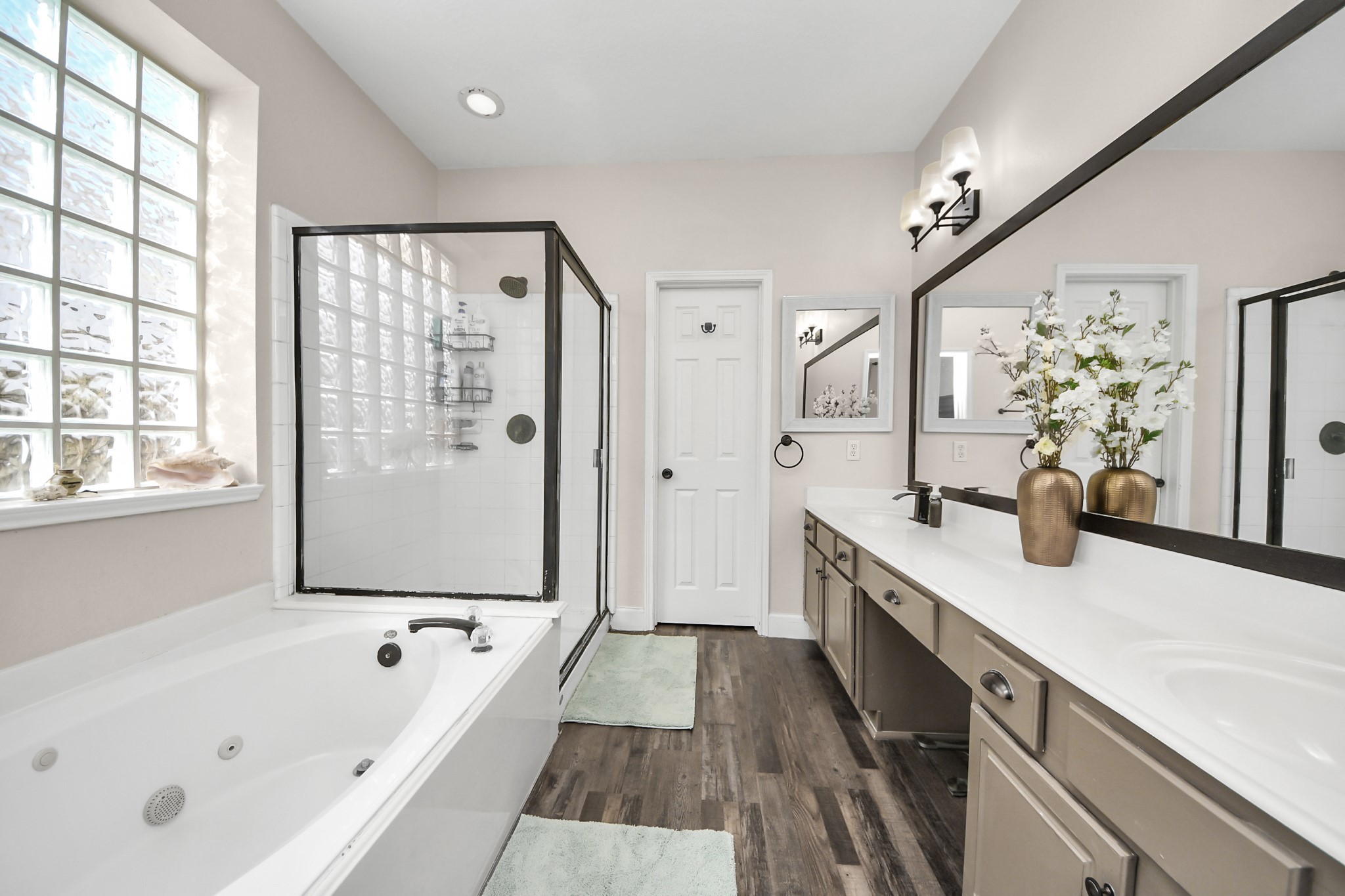 10514 Ravens Way Baytown, TX 77523 - Photo 44 of 50 Perspective from the doorway, capturing both the garden tub and shower, perfect for comfort and convenience.