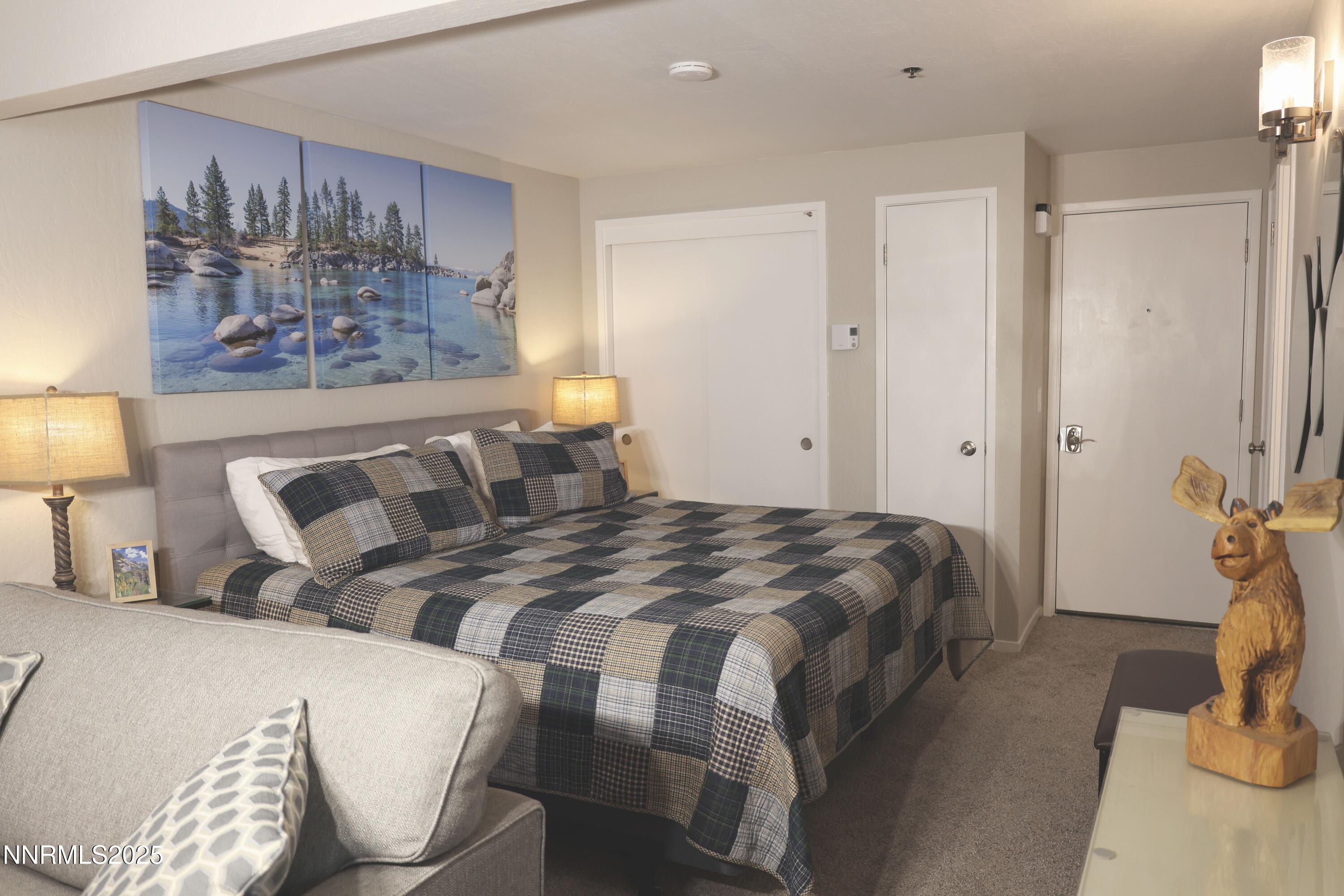 313 Tramway Drive, Unit 8 Stateline, NV 89449 - Photo 3 of 22 a bedroom with a bed and painting on the wall