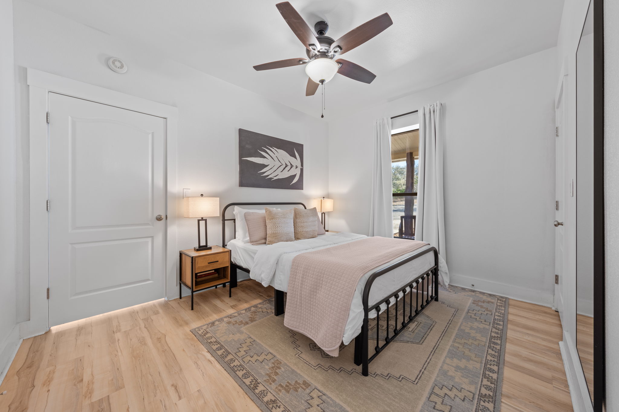 117 Point Road Fredericksburg, TX 78624 - Photo 13 of 40 Bedroom featuring light wood-style floors and ceiling fan