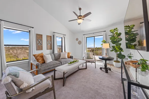 a living room with furniture a chandelier and a window