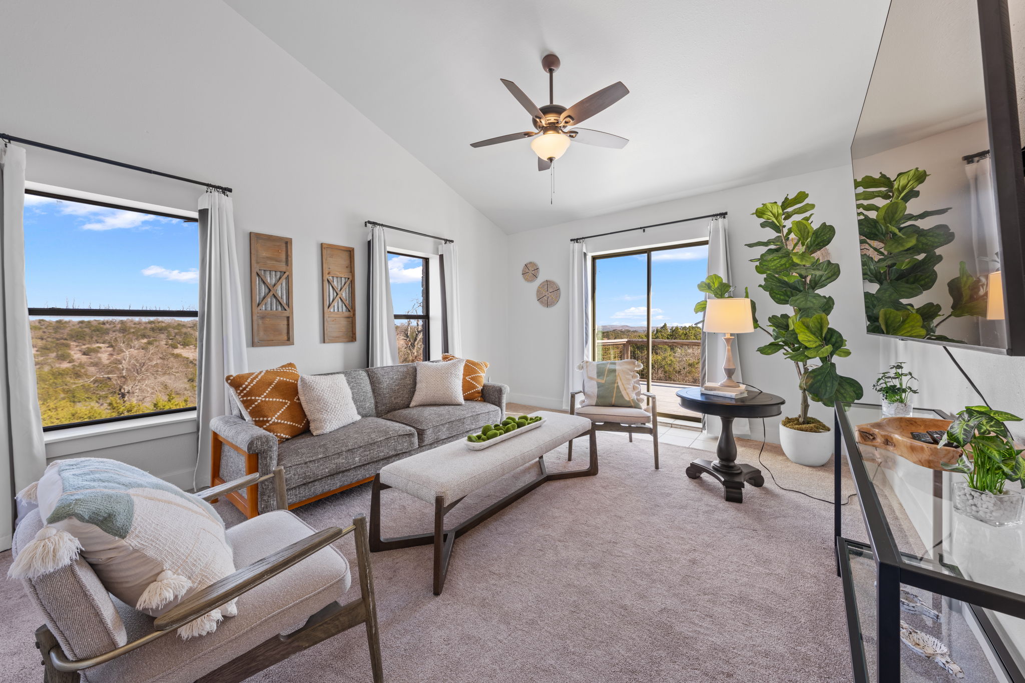 117 Point Road Fredericksburg, TX 78624 - Photo 19 of 40 Living room with vaulted ceiling, carpet floors, and ceiling fan