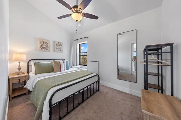 a bedroom with a large bed and a chandelier