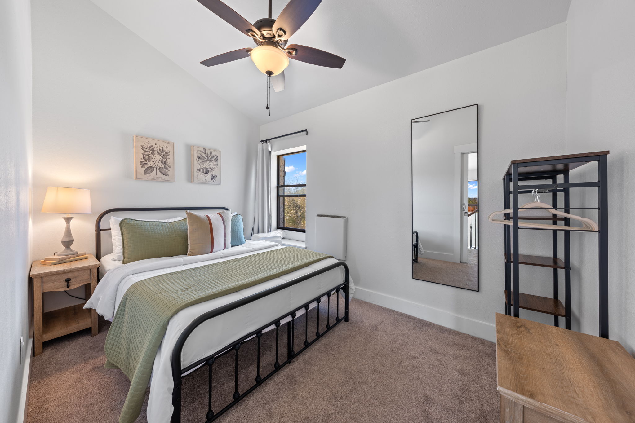 117 Point Road Fredericksburg, TX 78624 - Photo 21 of 40 Carpeted bedroom featuring vaulted ceiling and ceiling fan