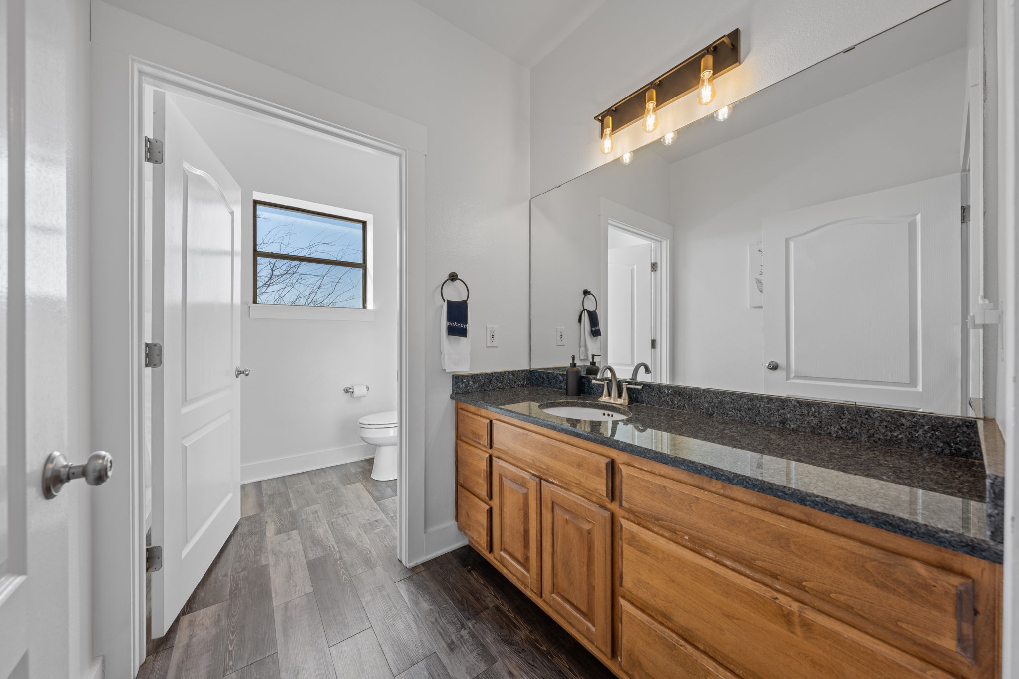 117 Point Road Fredericksburg, TX 78624 - Photo 23 of 40 Bathroom with vanity and dark wood-style floors