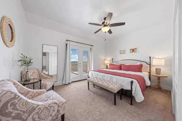 a bedroom with a bed and a chandelier