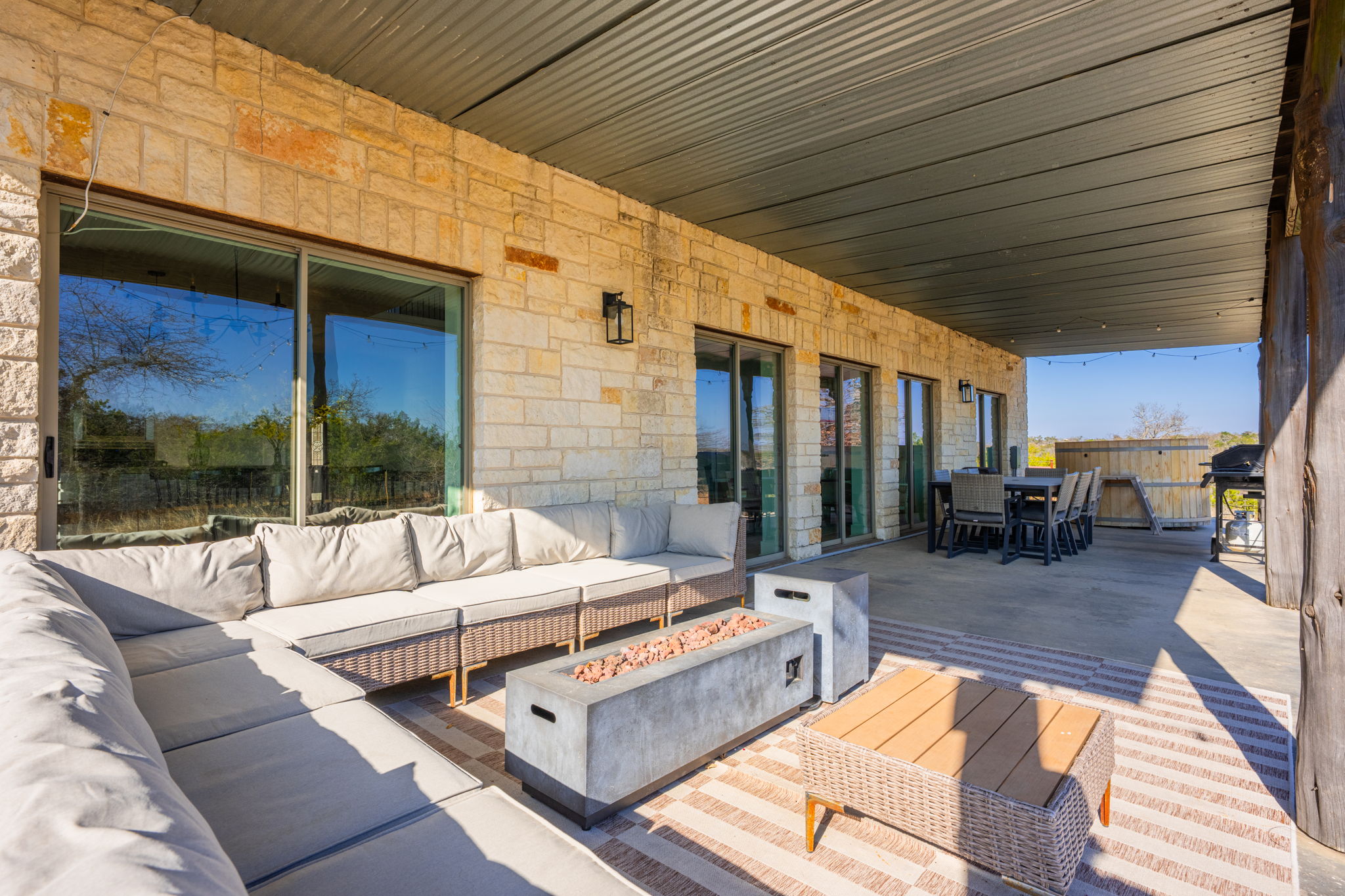 117 Point Road Fredericksburg, TX 78624 - Photo 27 of 40 Deck with an outdoor living / dining area, an outdoor fire pit, area for grilling, and a patio