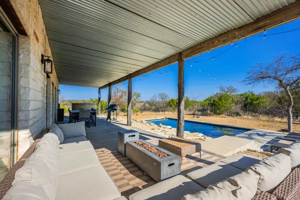 a view of a patio with swimming pool