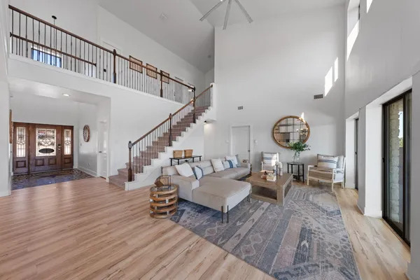 a living room with furniture and a wooden floor