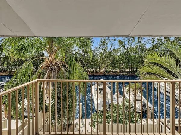 a view of balcony with a couple of palm trees