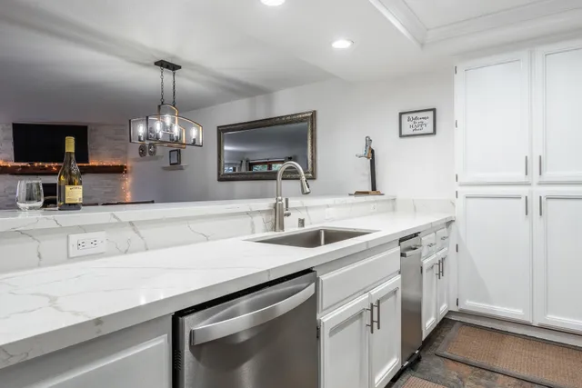 a kitchen with a sink and a refrigerator
