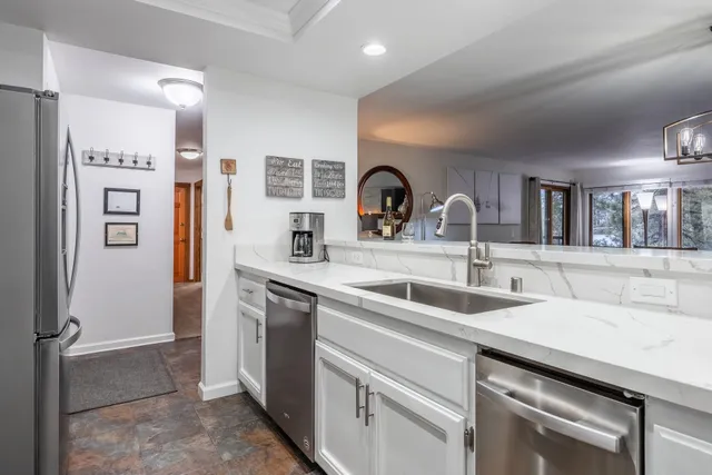 a kitchen with a sink and a refrigerator