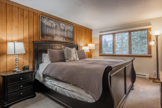 a view of a bedroom with furniture and flat screen tv