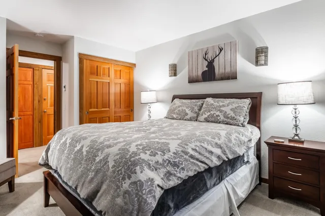 a bedroom with a bed and a dresser next to a window