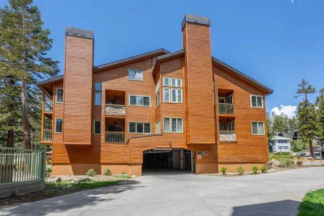 a view of a house with a yard and a garage
