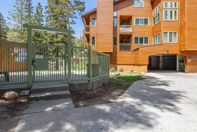 a view of a house with a wooden fence
