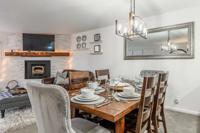 a view of a dining room with furniture wooden floor and chandelier