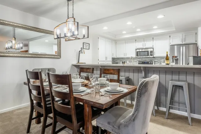a dining table with kitchen view and kitchen view