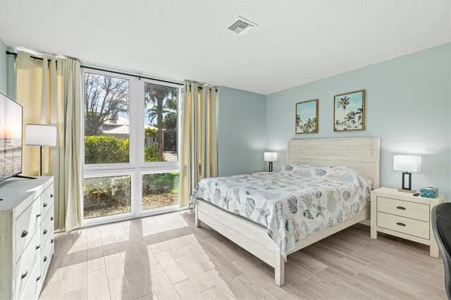 a bedroom with a large bed and a large window