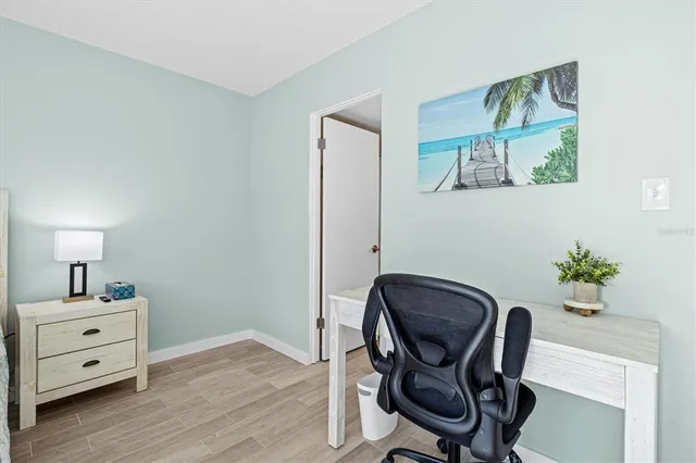 a view of a workspace with furniture and wooden floor