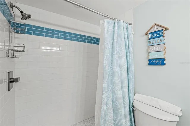 a bathroom with a shower a toilet and a shower