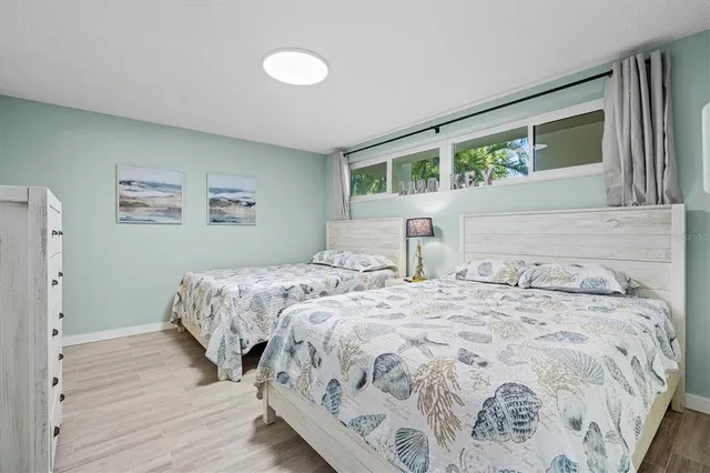 a bedroom with a large bed and a window