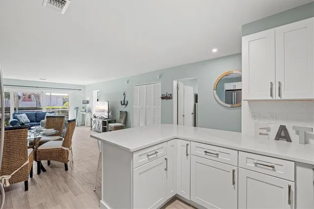 a view of a kitchen area with furniture and wooden floor