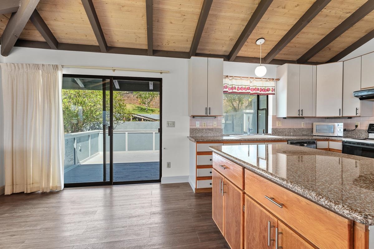700 South Alu Road Wailuku, HI 96793 - Photo 12 of 42 a kitchen with stainless steel appliances granite countertop a sink a stove and a wooden floors