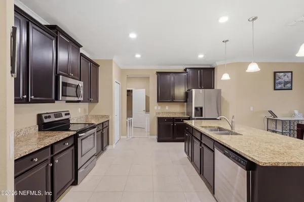 a kitchen with stainless steel appliances granite countertop refrigerator stove microwave and cabinets