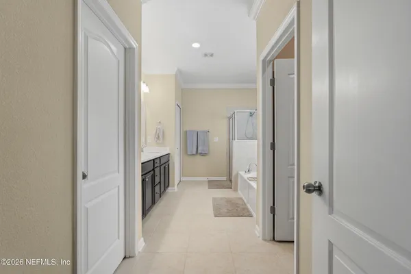 a view of a hallway with closet and a fireplace