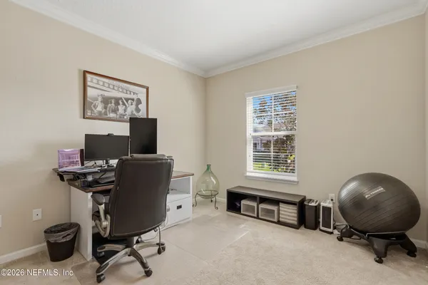 a view of a workspace with furniture and a window