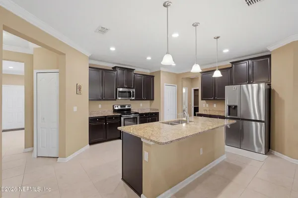 a large kitchen with stainless steel appliances kitchen island a large island in the center
