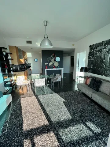 a living room with furniture and a rug