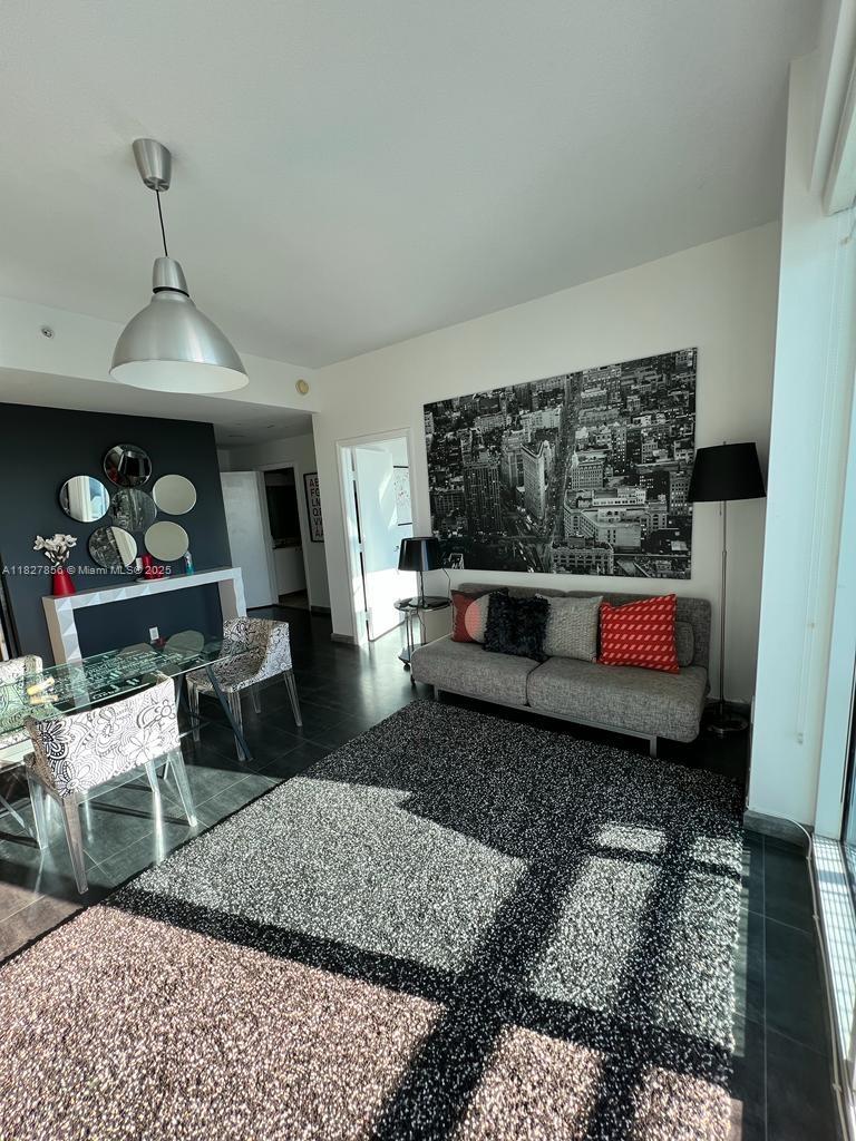 60 Southwest 13th Street, Unit 3407 Miami, FL 33130 - Photo 14 of 24 a living room with furniture and a rug