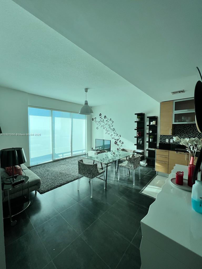 60 Southwest 13th Street, Unit 3407 Miami, FL 33130 - Photo 16 of 24 a living room with furniture and a flat screen tv