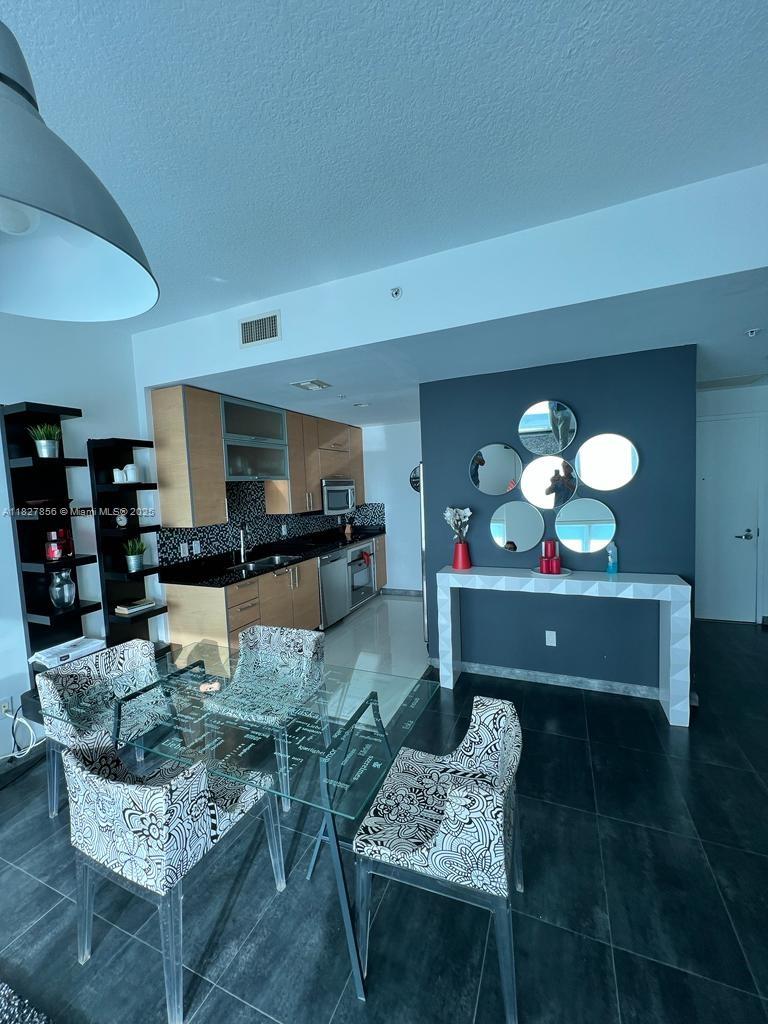 60 Southwest 13th Street, Unit 3407 Miami, FL 33130 - Photo 19 of 24 a living room with furniture and a wooden floor