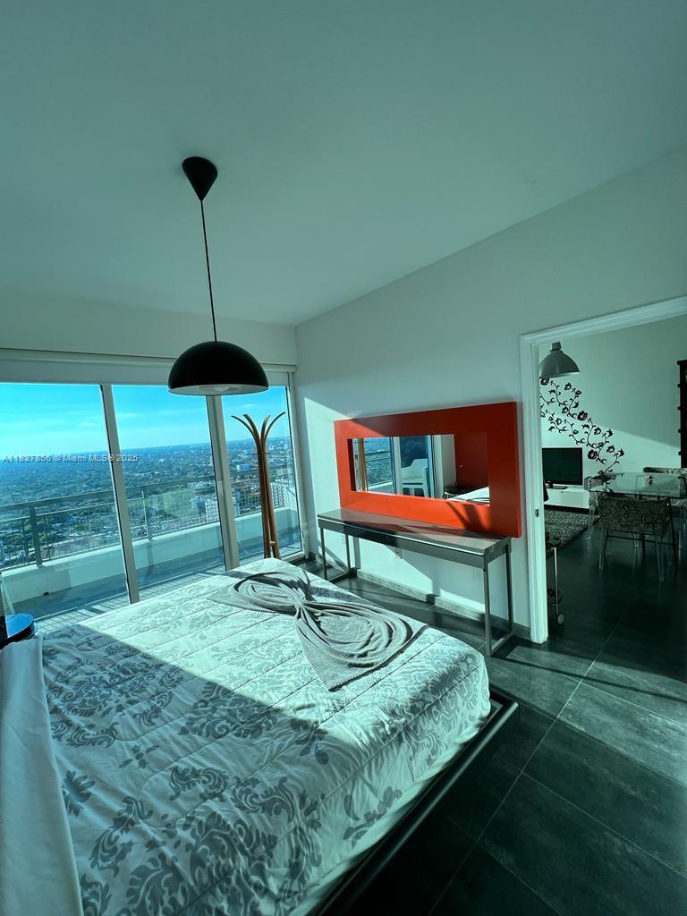 60 Southwest 13th Street, Unit 3407 Miami, FL 33130 - Photo 2 of 24 a room with pool table and chairs