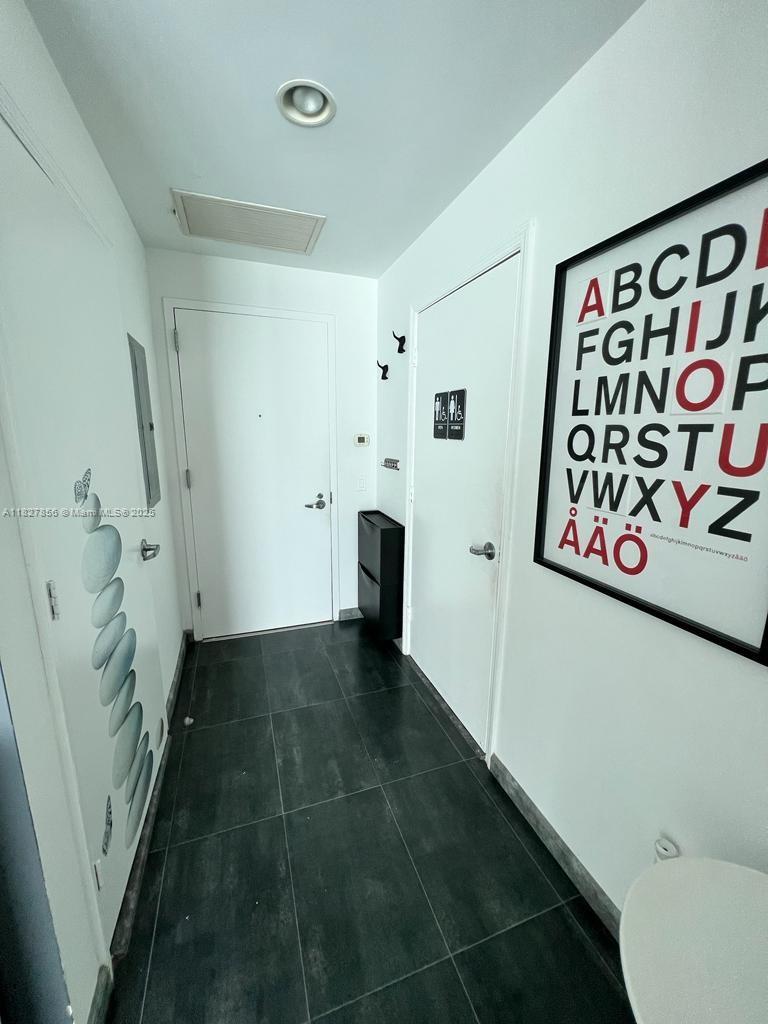 60 Southwest 13th Street, Unit 3407 Miami, FL 33130 - Photo 21 of 24 a view of entryway with stairs and wooden floor