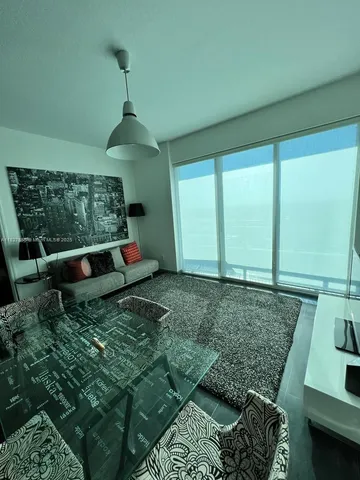 a living room with furniture and a rug