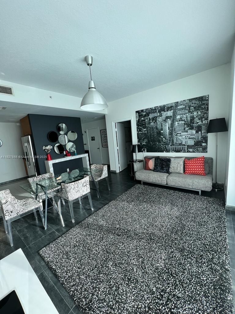 60 Southwest 13th Street, Unit 3407 Miami, FL 33130 - Photo 5 of 24 a living room with furniture and a rug