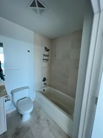 a spacious bathroom with a sink and a mirror