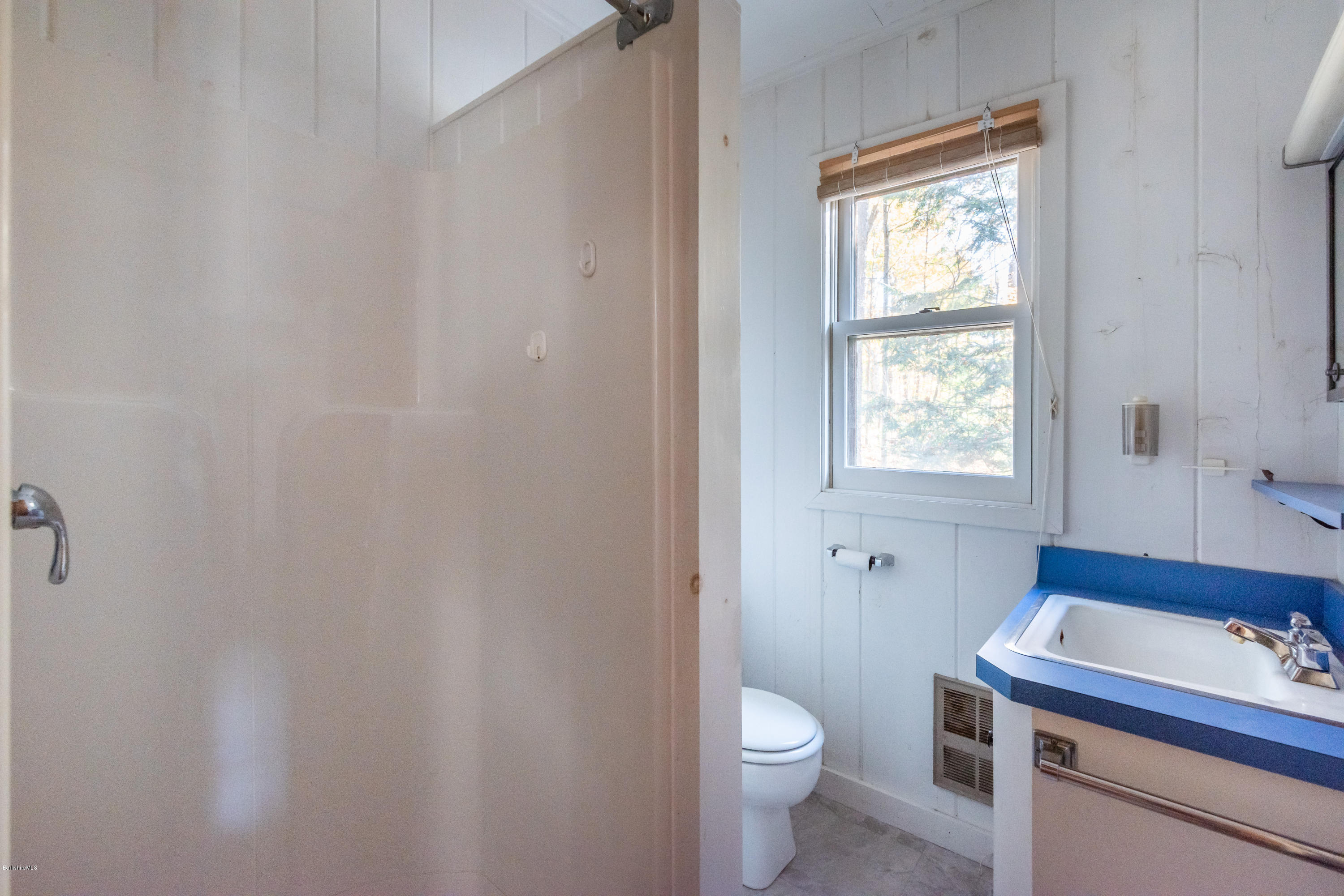 10 Housatonnuck Road Stockbridge, MA 01262 - Photo 22 of 30 a bathroom with a sink a toilet and a window