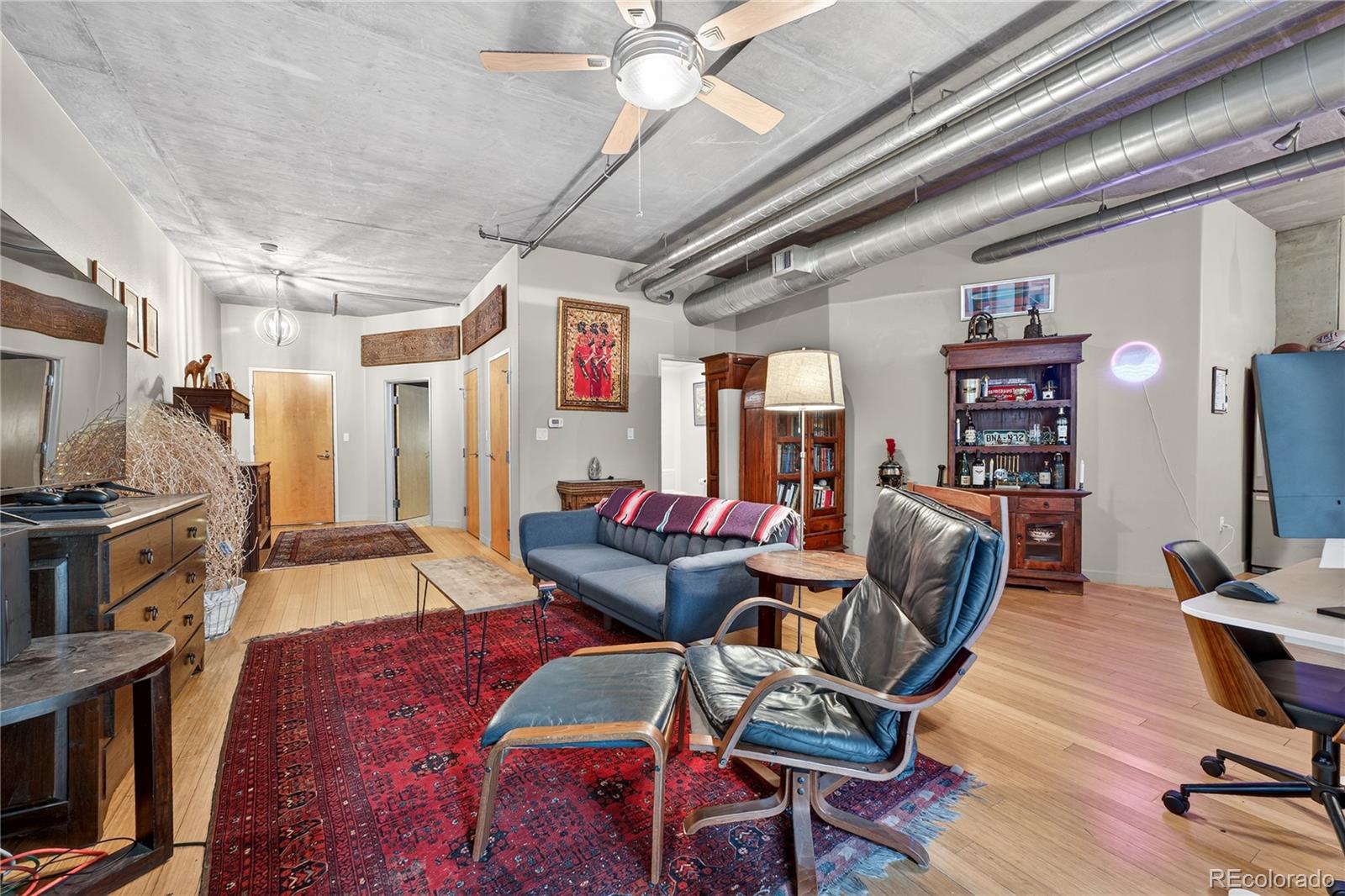 1401 Wewatta Street, Unit 305 Denver, CO 80202 - Photo 11 of 45 a living room with furniture and a flat screen tv