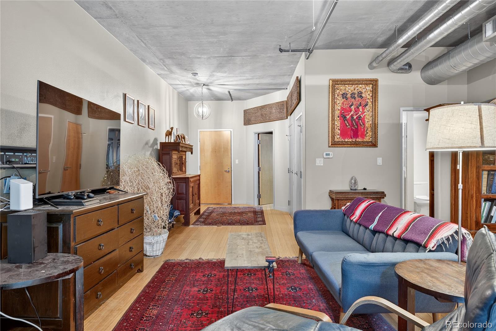 1401 Wewatta Street, Unit 305 Denver, CO 80202 - Photo 13 of 45 a living room with furniture ceiling fan and a rug