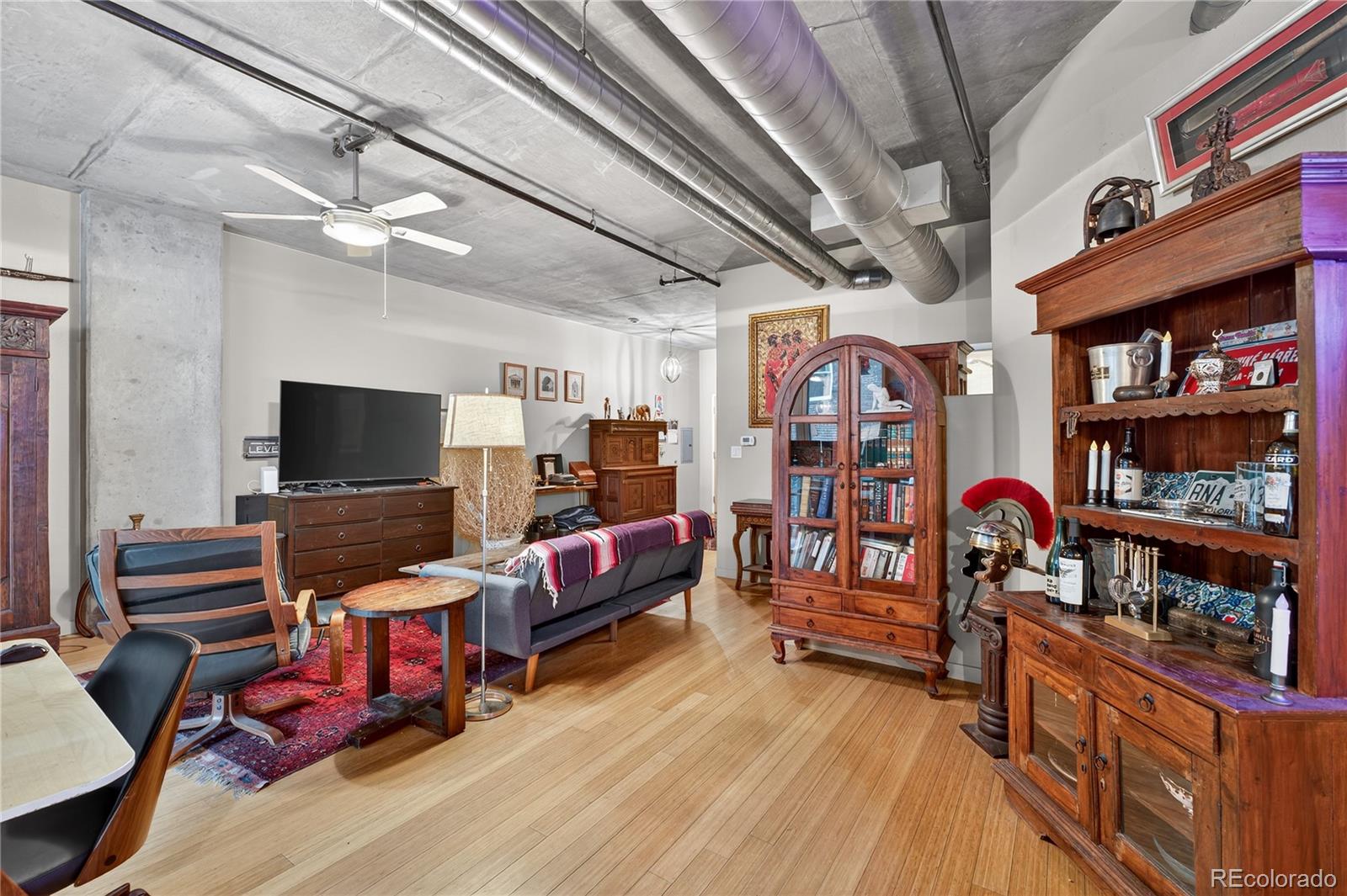 1401 Wewatta Street, Unit 305 Denver, CO 80202 - Photo 14 of 45 a room with lots of furniture and wooden floor