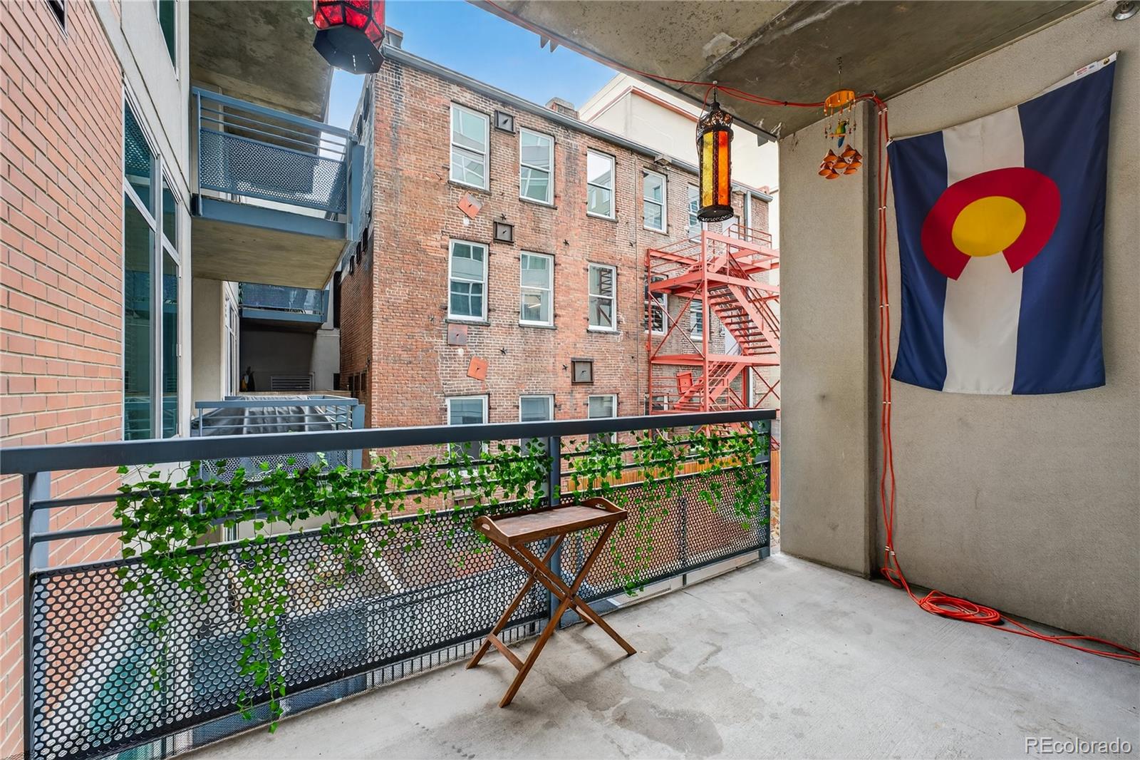 1401 Wewatta Street, Unit 305 Denver, CO 80202 - Photo 16 of 45 a view of a building with a potted plant and a bench
