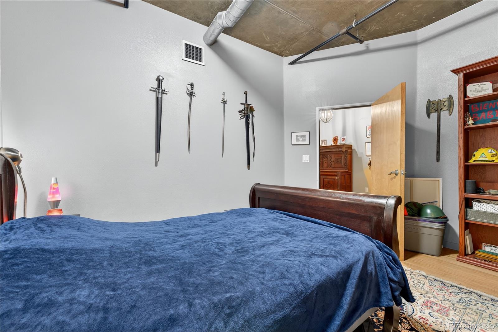 1401 Wewatta Street, Unit 305 Denver, CO 80202 - Photo 24 of 45 a bedroom with a large bed and a dresser