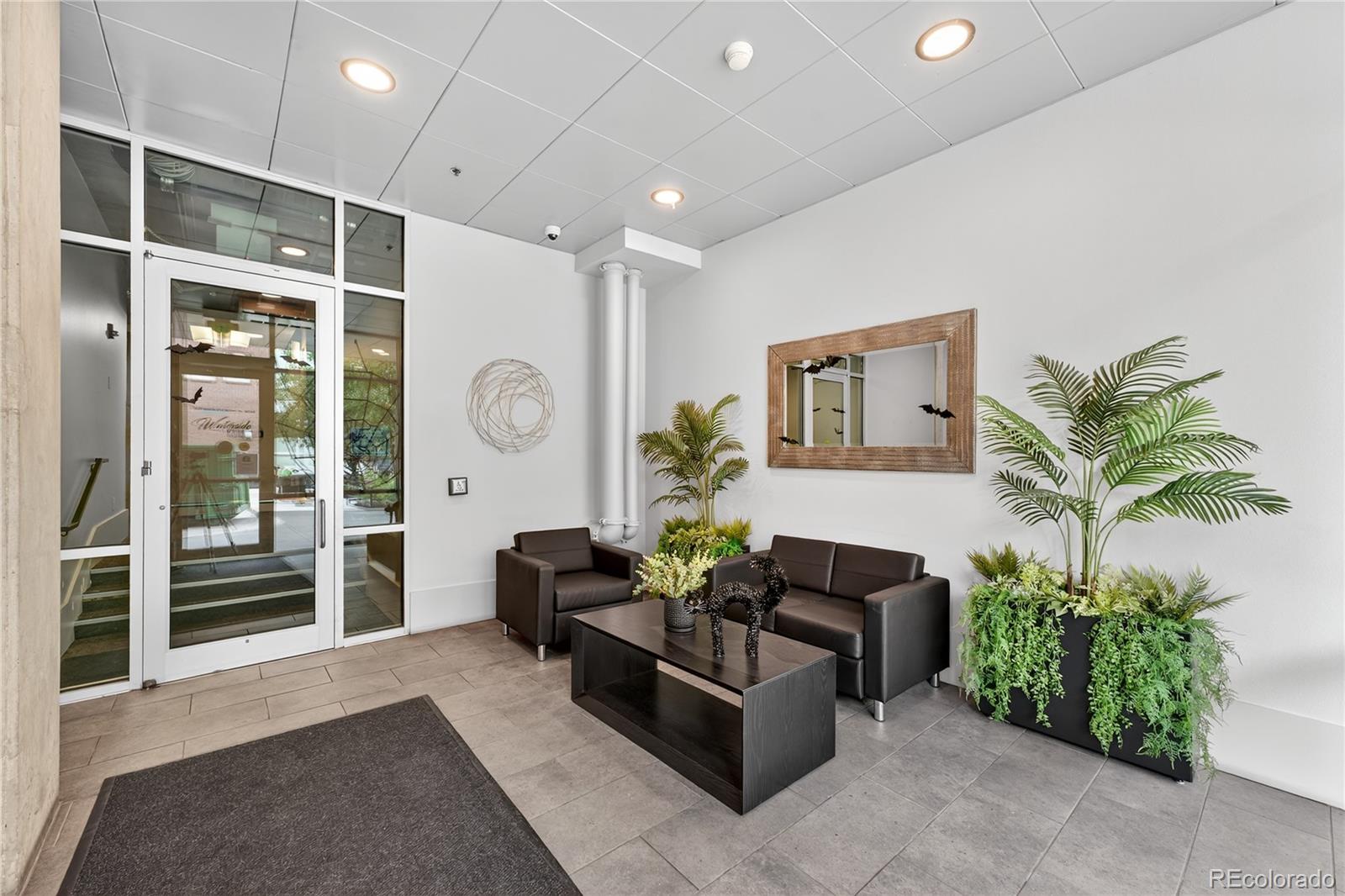 1401 Wewatta Street, Unit 305 Denver, CO 80202 - Photo 30 of 45 a living room with furniture potted plant and a window